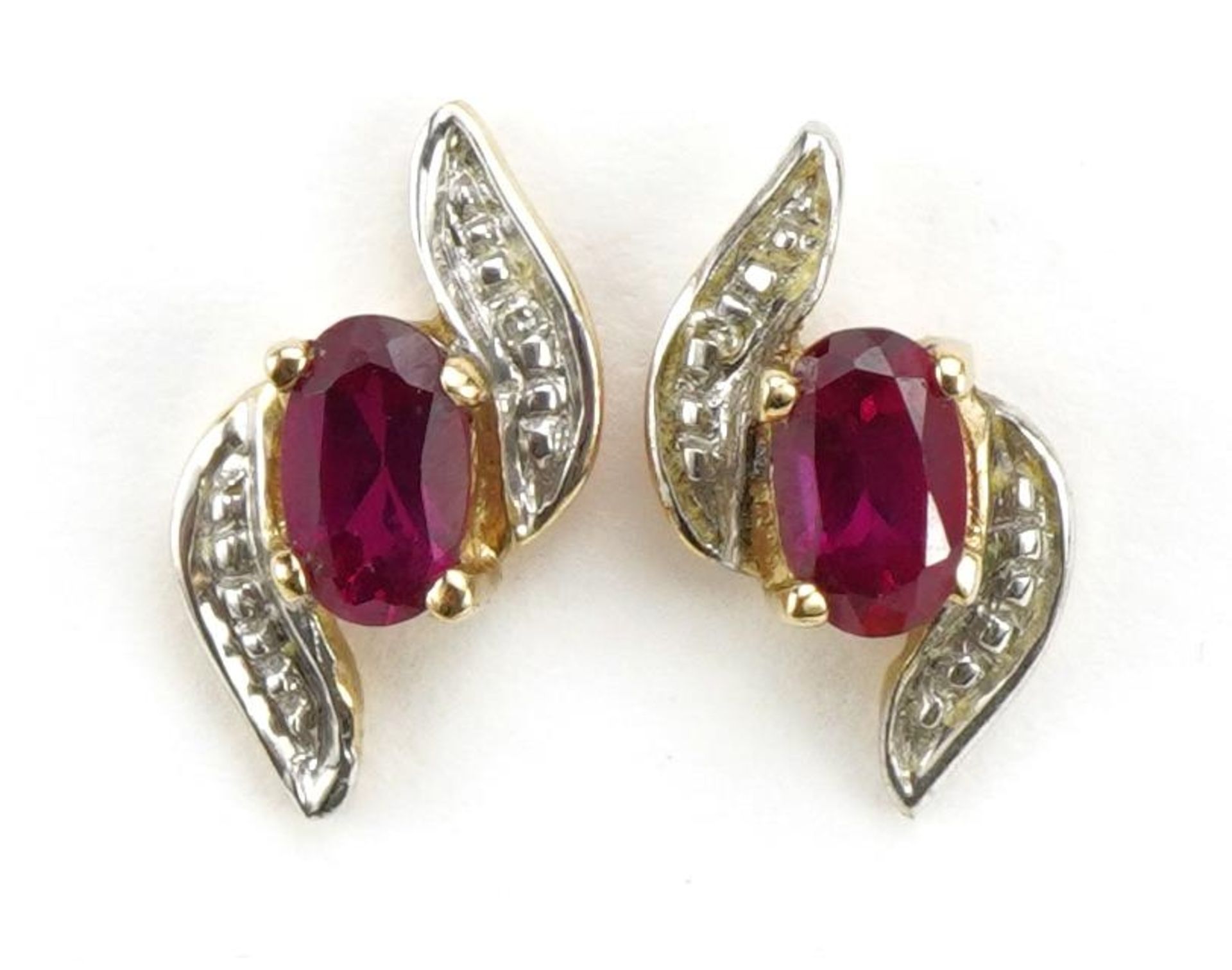 Pair of unmarked gold ruby and diamond crossover stud earrings, 1.2cm high, 0.9g