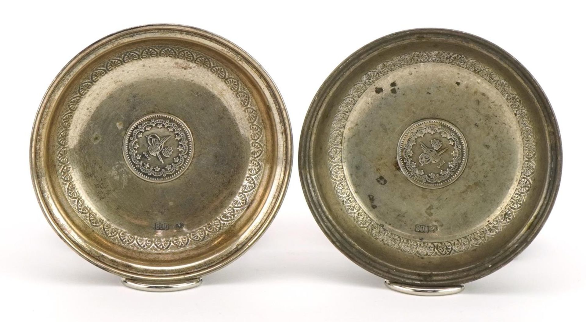 Pair of Persian circular 800 grade coin set silver dishes, 7cm in diameter, 28.2g