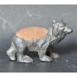 LATE VICTORIAN WHITE METAL PIN CUSHION IN THE FORM OF A BEAR