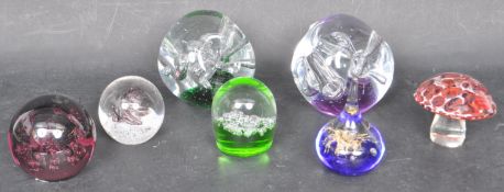 ASSORTMENT OF SEVEN GLASS PAPERWEIGHTS