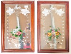 A pair of Victorian bevelled edge decorated gypsy mirrors with central flower basket arrangement and