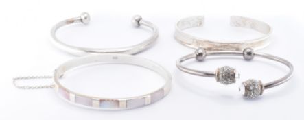 FOUR SILVER BANGLE BRACELETS