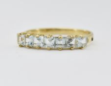 9CT GOLD & AQUAMARINE SEVEN STONE RING