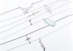 COLLECTION OF SEVEN SILVER PENDANT NECKLACES