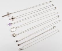 EIGHT SILVER PENDANT NECKLACES