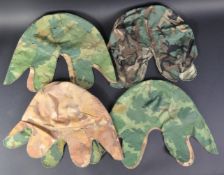 COLLECTION OF FOUR 20TH CENTURY CAMOUFLAGE HELMET COVERS