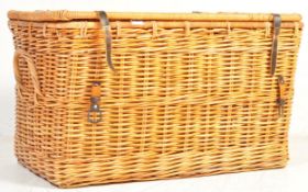A large 20th century wicker basket having a hinged lid opening to reveal a spacious interior. The