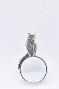 SILVER MAGNIFYING GLASS CAT PENDANT.