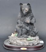 CONTEMPORARY RESIN STATUE OF A SEATED BEAR