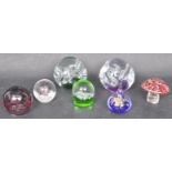 ASSORTMENT OF SEVEN GLASS PAPERWEIGHTS