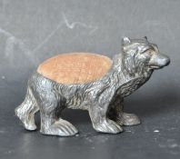LATE VICTORIAN WHITE METAL PIN CUSHION IN THE FORM OF A BEAR
