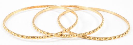 THREE MIDDLE EASTERN GOLD BANGLE BRACELETS