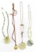 FOUR CARVED GREEN STONE NECKLACES