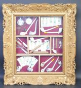COLLECTIONOF VINTAGE PIPES AND CURIOS SET WITH A GILT FRAME
