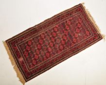 20TH CENTURY PERSIAN ISLAMIC RUG WITH RED GEOMETRIC BACKGROUND