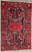 AN EARLY 20TH CENTURY HAND KNOTTED PERSIAN NAHAWAND RUG