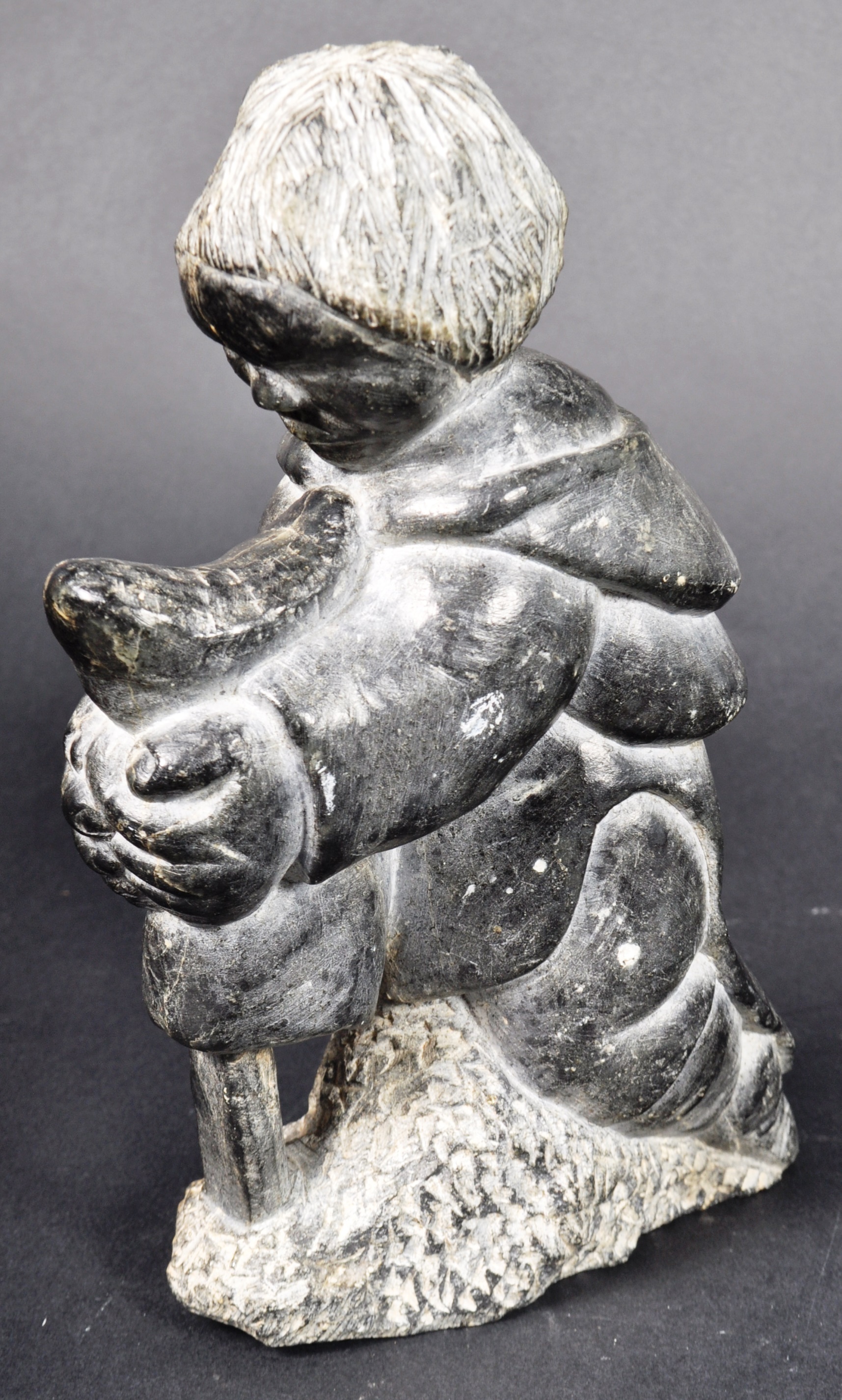 DAVIDEE SAUMIK - INUIT ART CARVED FIGURINE OF BOY SKINNING A SEAL