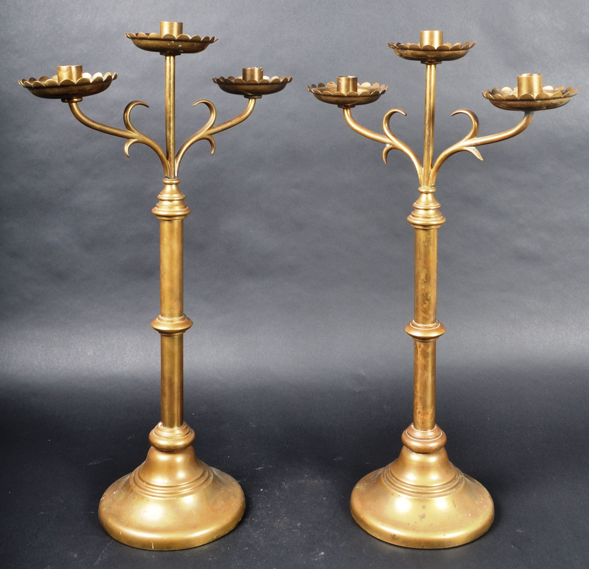 PAIR OF 19TH CENTURY GOTHIC BRASS TRIPLE CANDLESTICKS