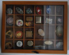 ASSORTMENT OF VINTAGE PILL POTS IN DISPLAY CASE