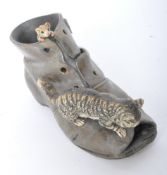 A VINTAGE COLD PAINTED BRONZE OF A BOOT AND A CAT