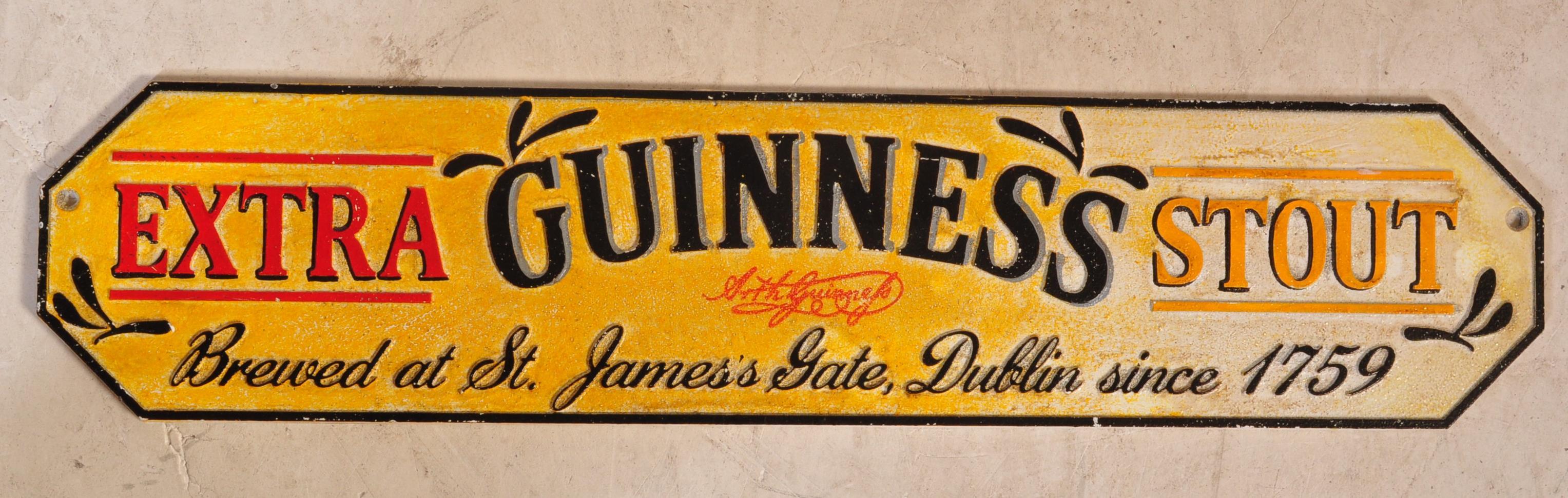 A VINTAGE STYLE CAST IRON GUINNESS EXTRA STOUT SIGN