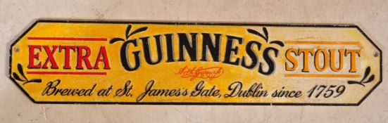 A VINTAGE STYLE CAST IRON GUINNESS EXTRA STOUT SIGN