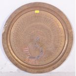 A LARGE BRASS PEACOCK CHARGER / PLATE