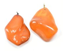 TWO AMBER NUGGET PENDANTS