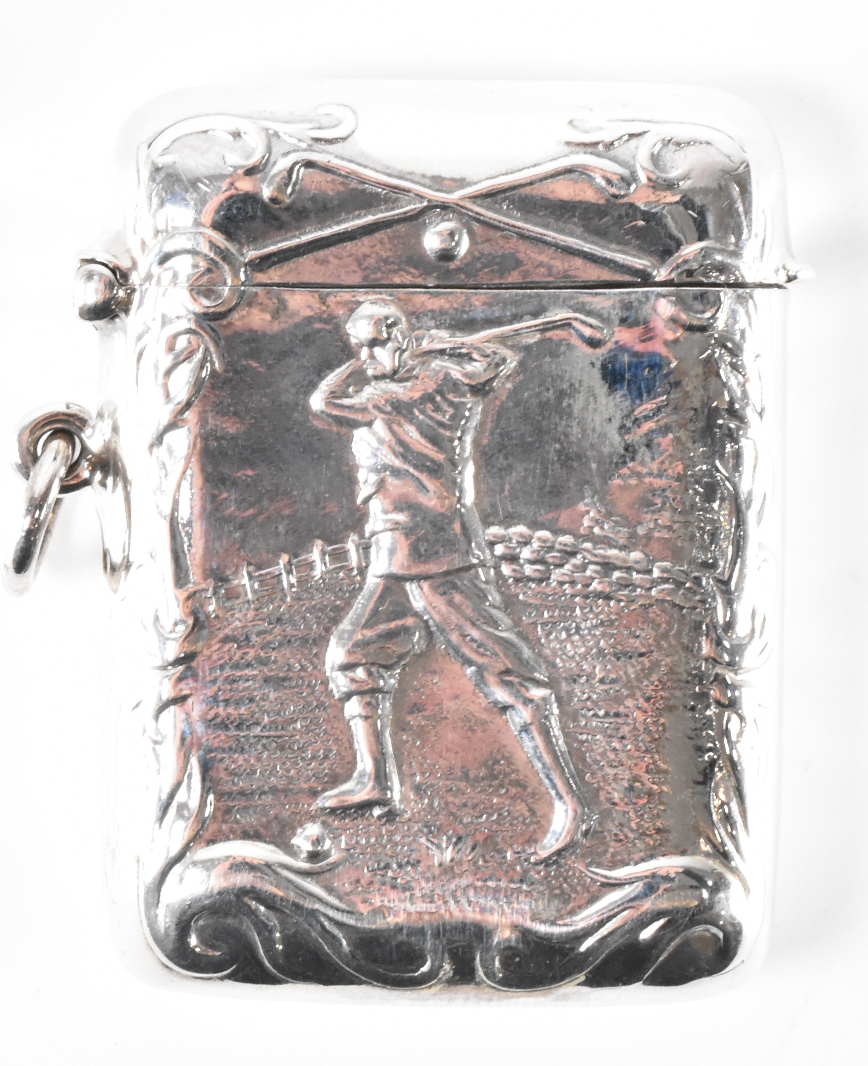 A SILVER VESTA CASE WITH GOLFING EMBOSSED DECORATIONS