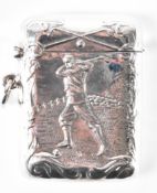 A SILVER VESTA CASE WITH GOLFING EMBOSSED DECORATIONS