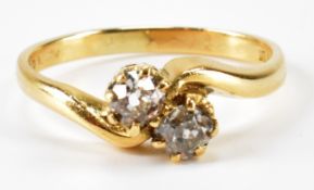 A HALLMARKED 18CT GOLD AND DIAMOND CROSSOVER RING