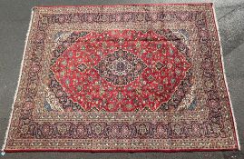 AN EARLY 20TH CENTURY HAND KNOTTED PERSIAN KASHAN RUG