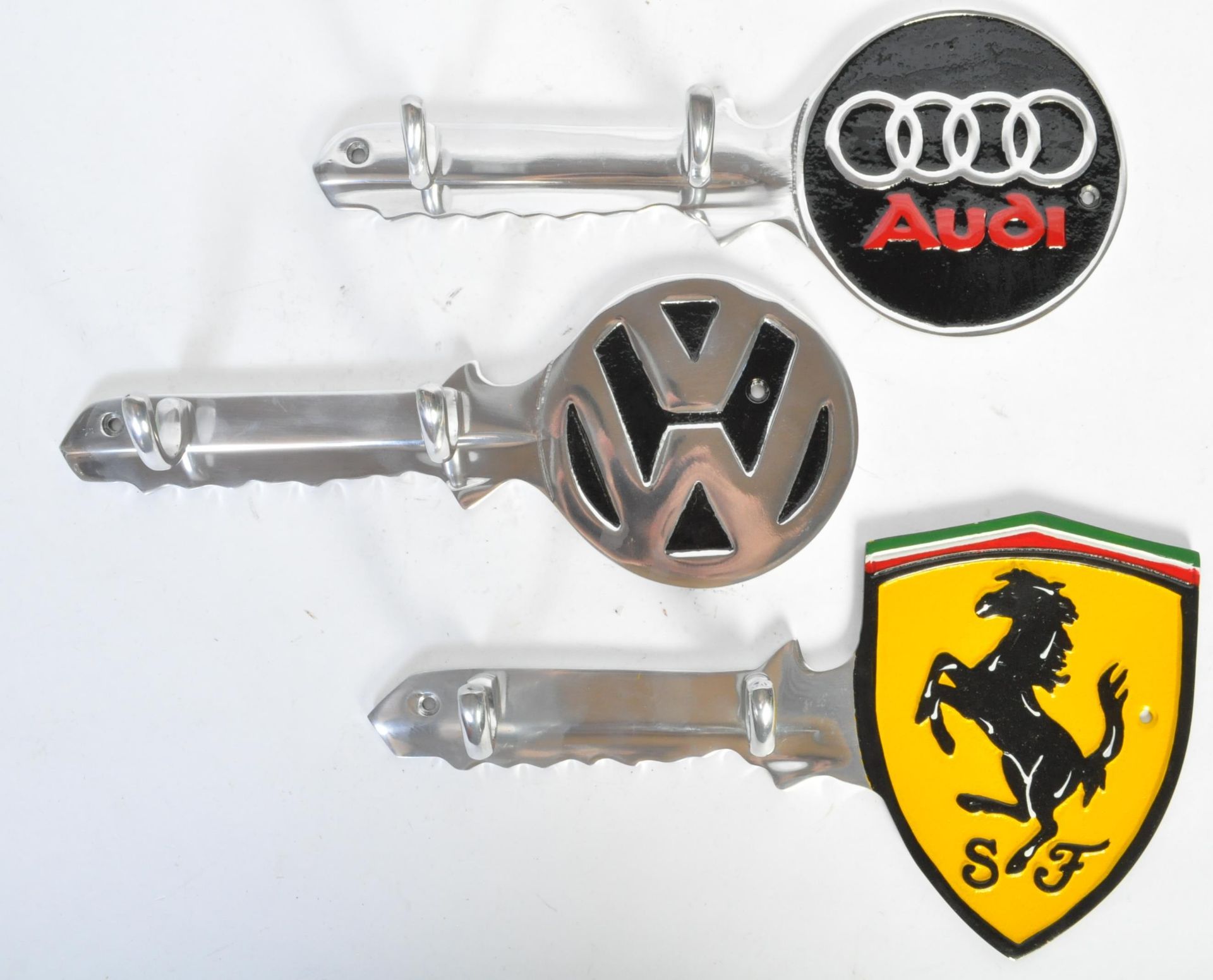 THREE VINTAGE CAST ALUMINIUM FERRARI, AUDI & VW KEY HOLDERS