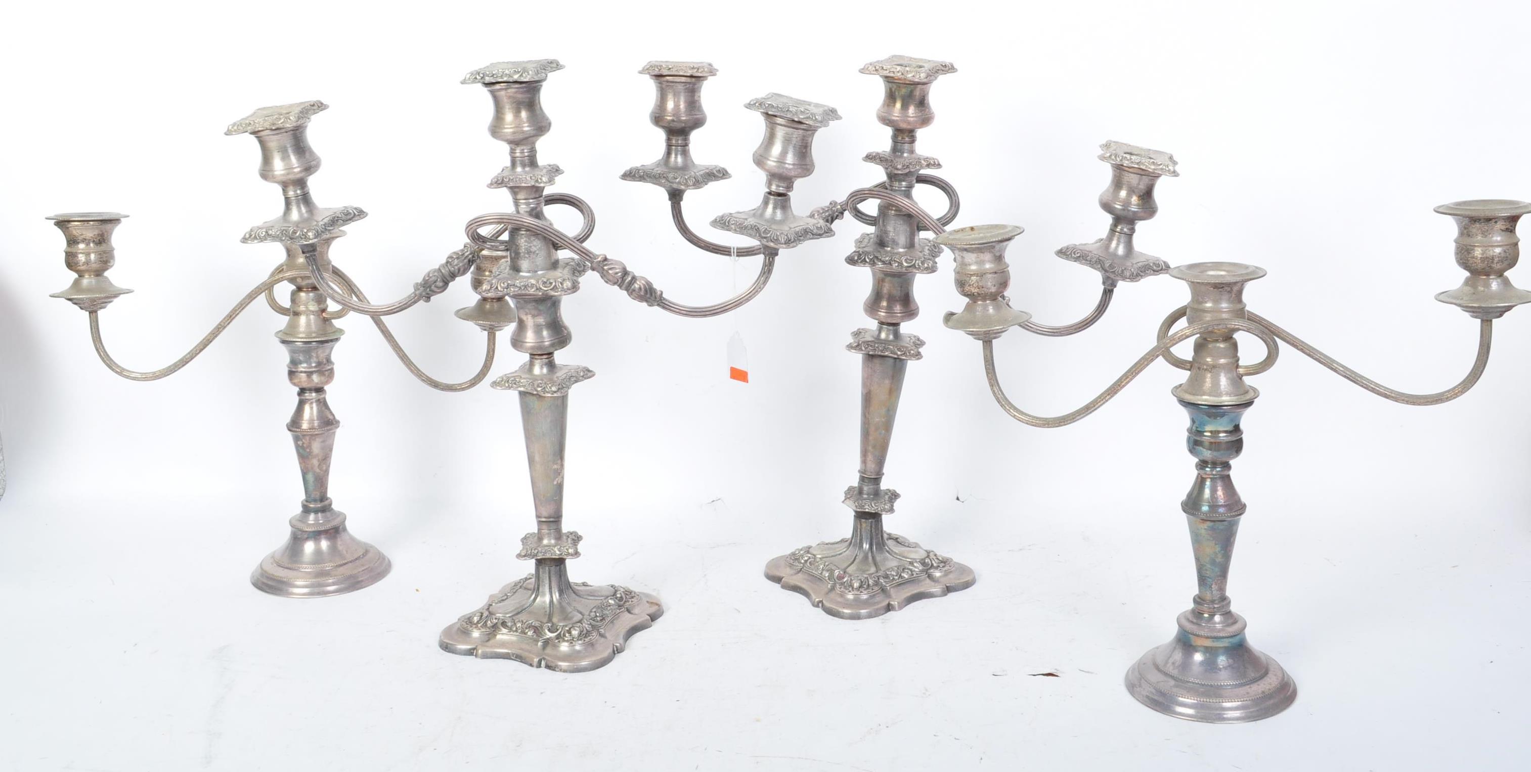 TWO PAIRS OF EARLY 20TH CENTURY SILVER PLATED CANDELABRA