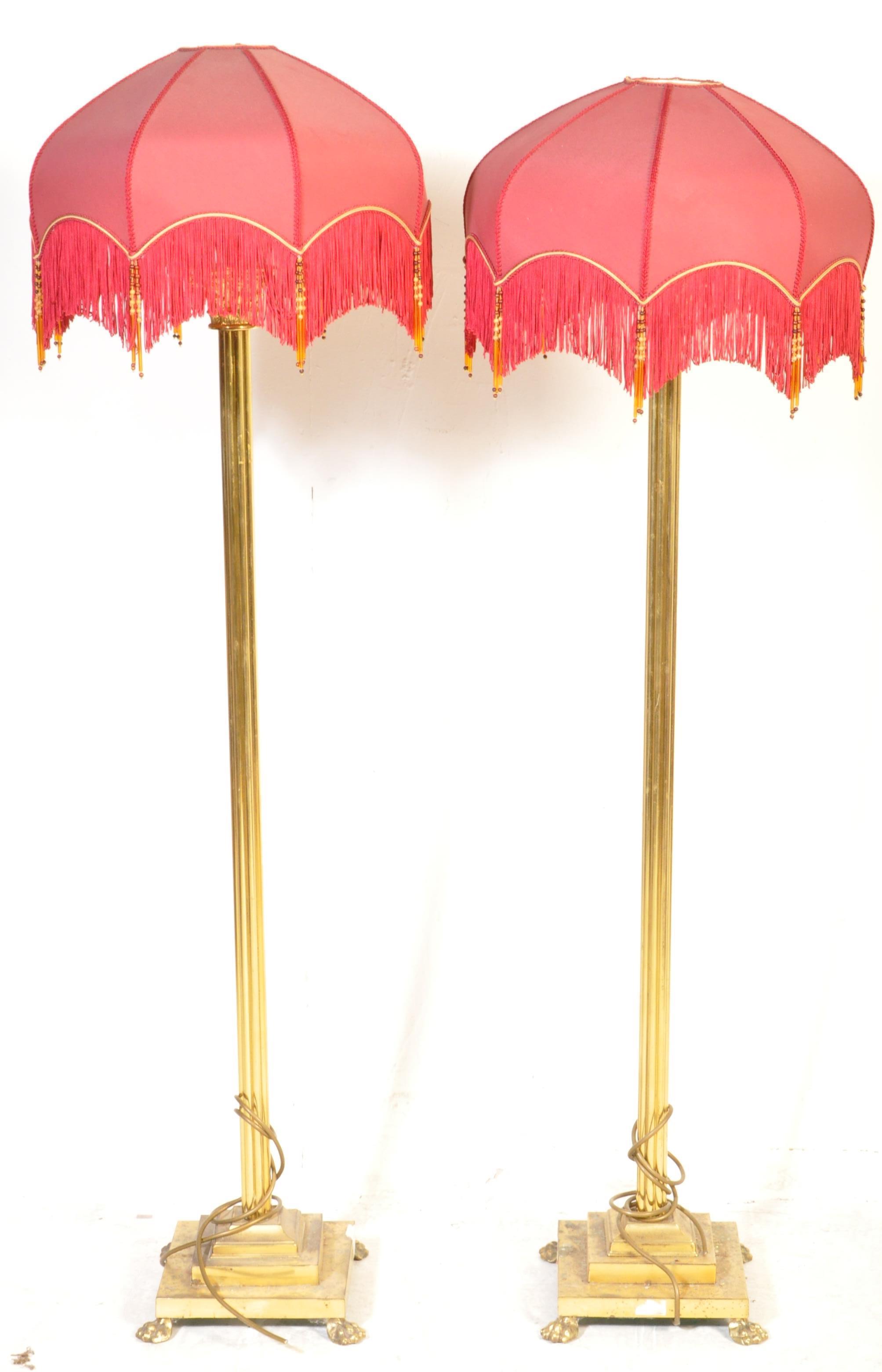 PAIR OF BRASS NEO CLASSICAL HAIRY PAW STANDARD FLOOR LAMPS