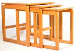 A RETRO VINTAGE TEAK NEST OF GRADUATING TABLES WITH TILED TOPS