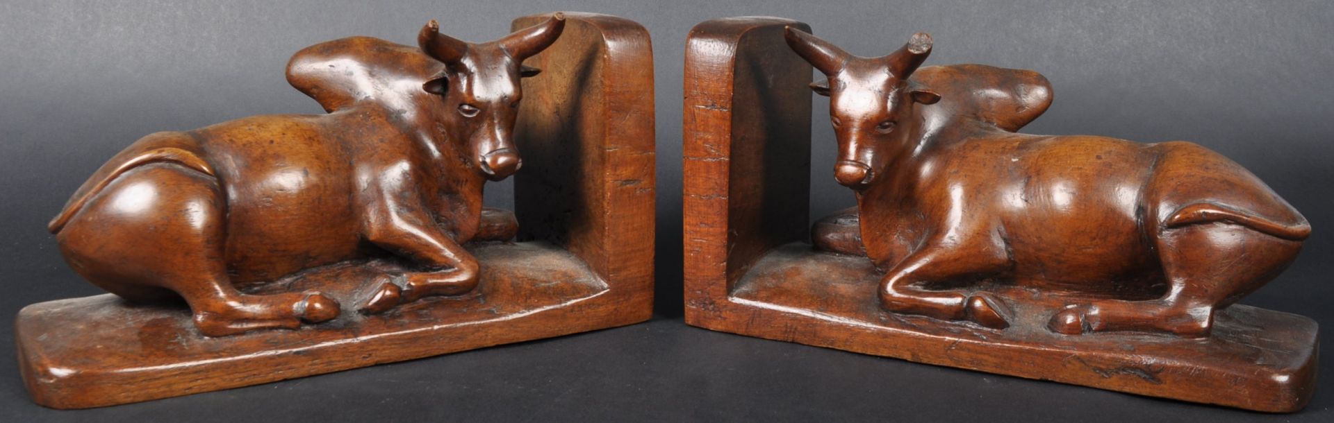 PAIR OF 19TH CENTURY CARVED WALNUT BUFFALO BOOKENDS