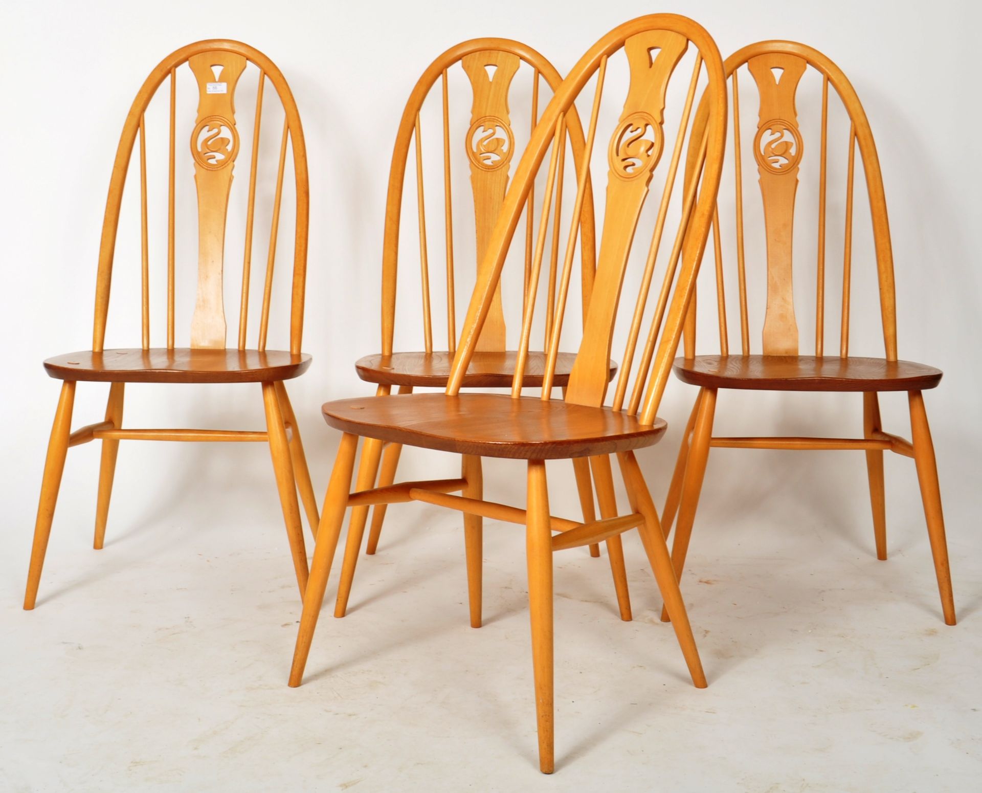 ERCOL - SWAN PATTERN - SET OF FOUR LIGHT DINING CHAIRS