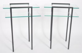 RODNEY KINSMAN - MATCHING PAIR OF TWO TIER GLASS TABLES