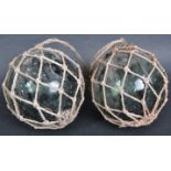 PAIR OF EARLY 20TH CENTURY PRESSED GREEN GLASS WITCHES BALLS