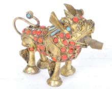 A VINTAGE 20TH CENTURY TIBETAN NAPALESE BRASS FOO DOG