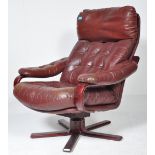 A RETRO CIRCA 1980S BURGUNDY LEATHER SWIVEL ARMCHAIR