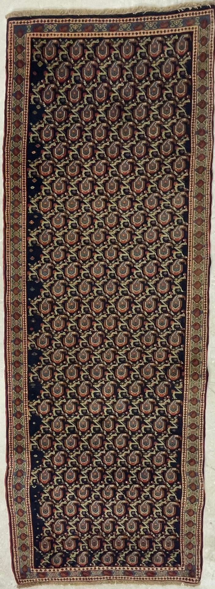 AN EARLY 20TH CENTURY KURDISH ISLAMIC RUNNER FLOOR RUG