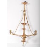 AN EARLY 20TH CENTURY TALL BRASS TIERED CEILING LIGHT