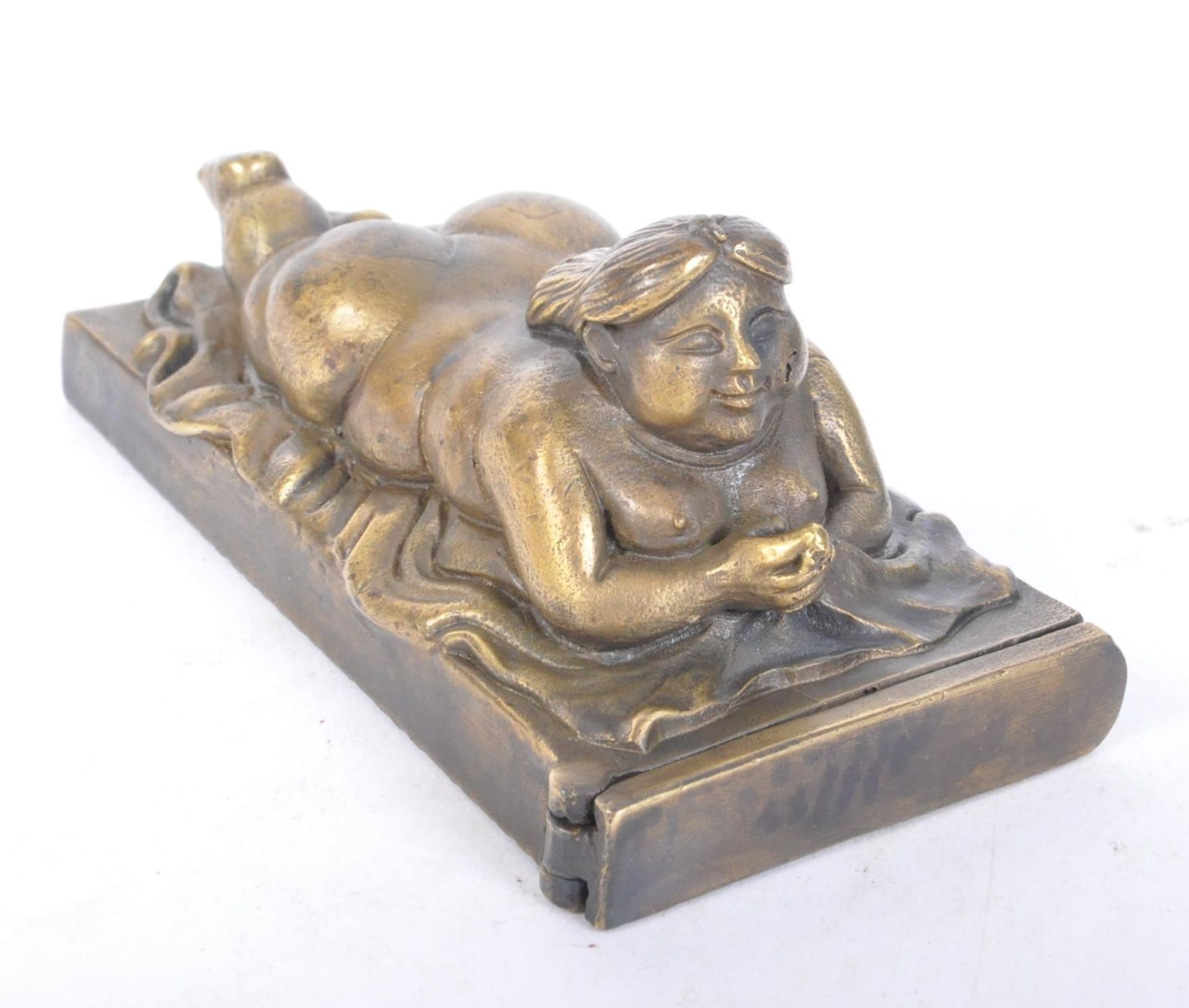 VINTAGE BRASS VESTA CASE IN THE FORM OF A RECLINING NUDE