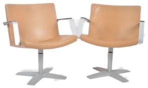 INNO - MATCHING PAIR OF LEATHER SWIVEL ARMCHAIRS