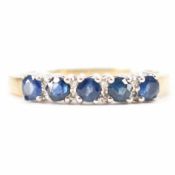 A hallmarked 9ct gold sapphire and diamond half eternity ring. The ring set with five round mixed