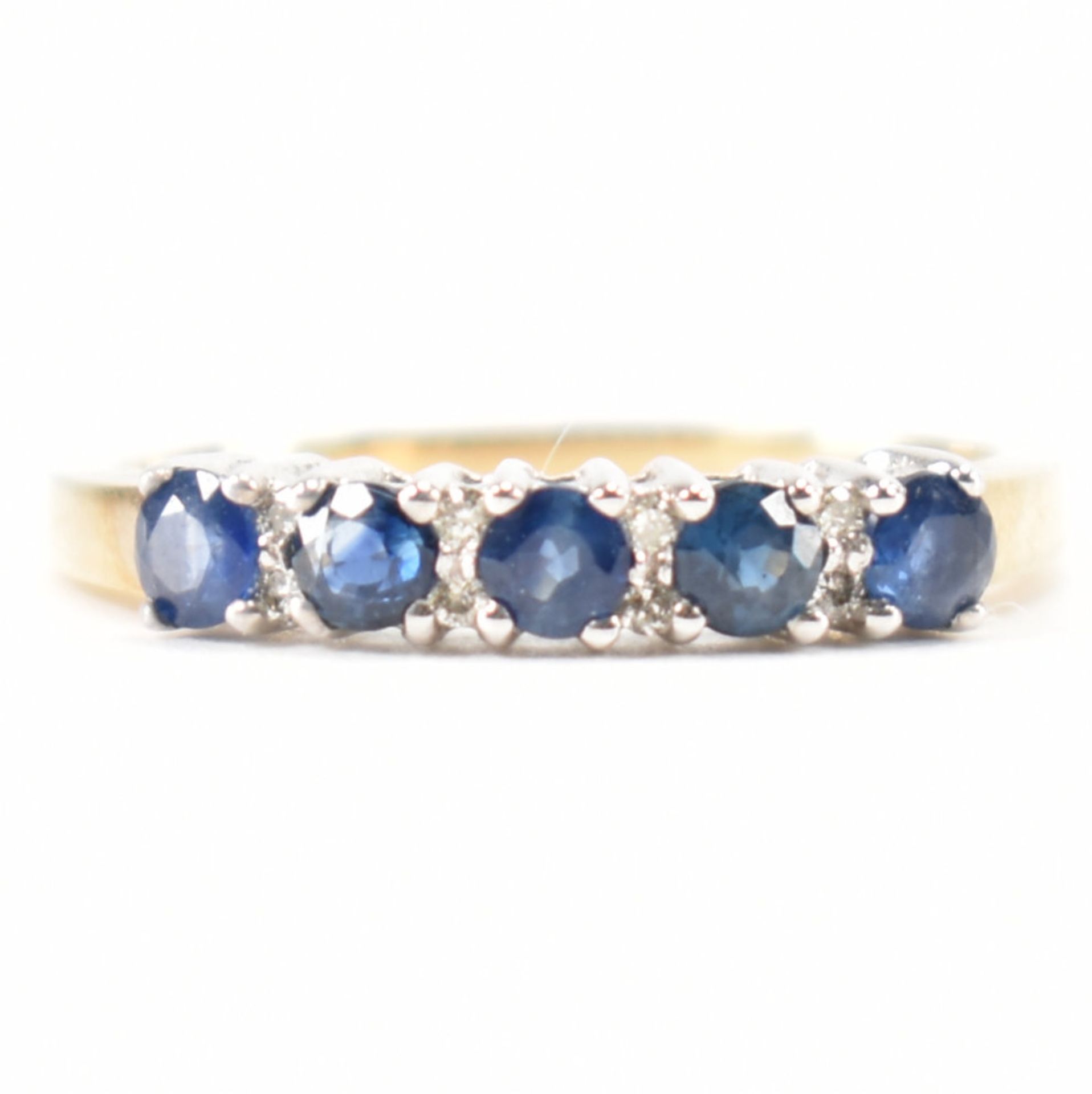 A hallmarked 9ct gold sapphire and diamond half eternity ring. The ring set with five round mixed