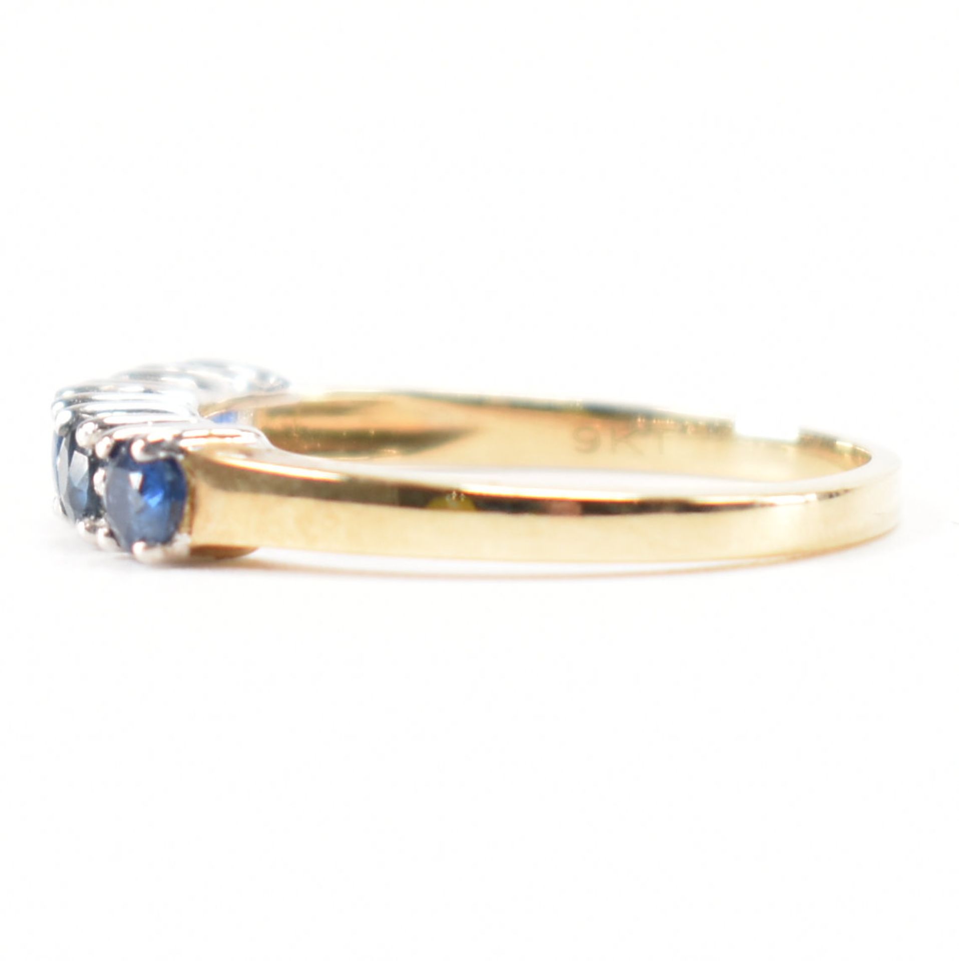 A hallmarked 9ct gold sapphire and diamond half eternity ring. The ring set with five round mixed - Image 2 of 9