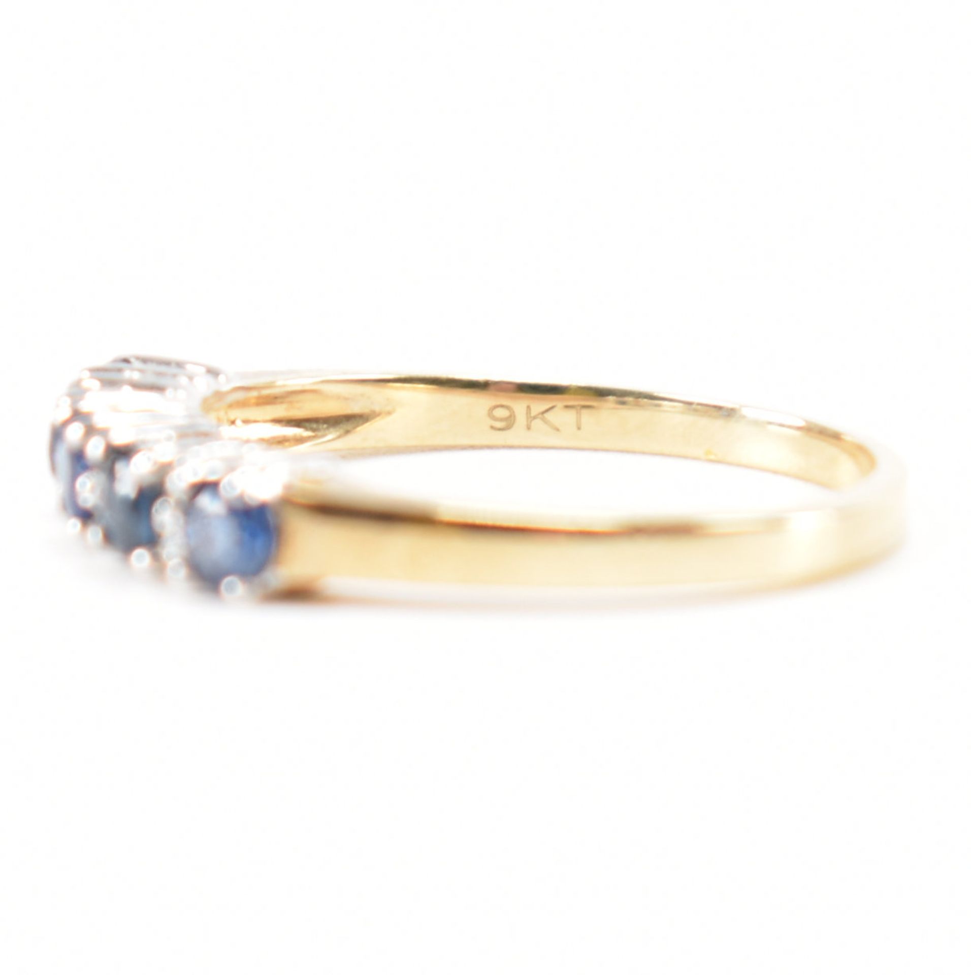 A hallmarked 9ct gold sapphire and diamond half eternity ring. The ring set with five round mixed - Image 7 of 9